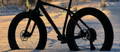 fat tire bicycle in snow at sunset