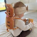 Close up on a toddler wearing a Tiger version of the Montessori Baby Guardian backpack.