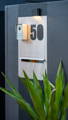 Lisse Wall Light illuminating the sign board of the North Bondi house