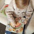 Montessori Christmas Joy Set featuring a puzzle board and wooden festive figurines and arches.