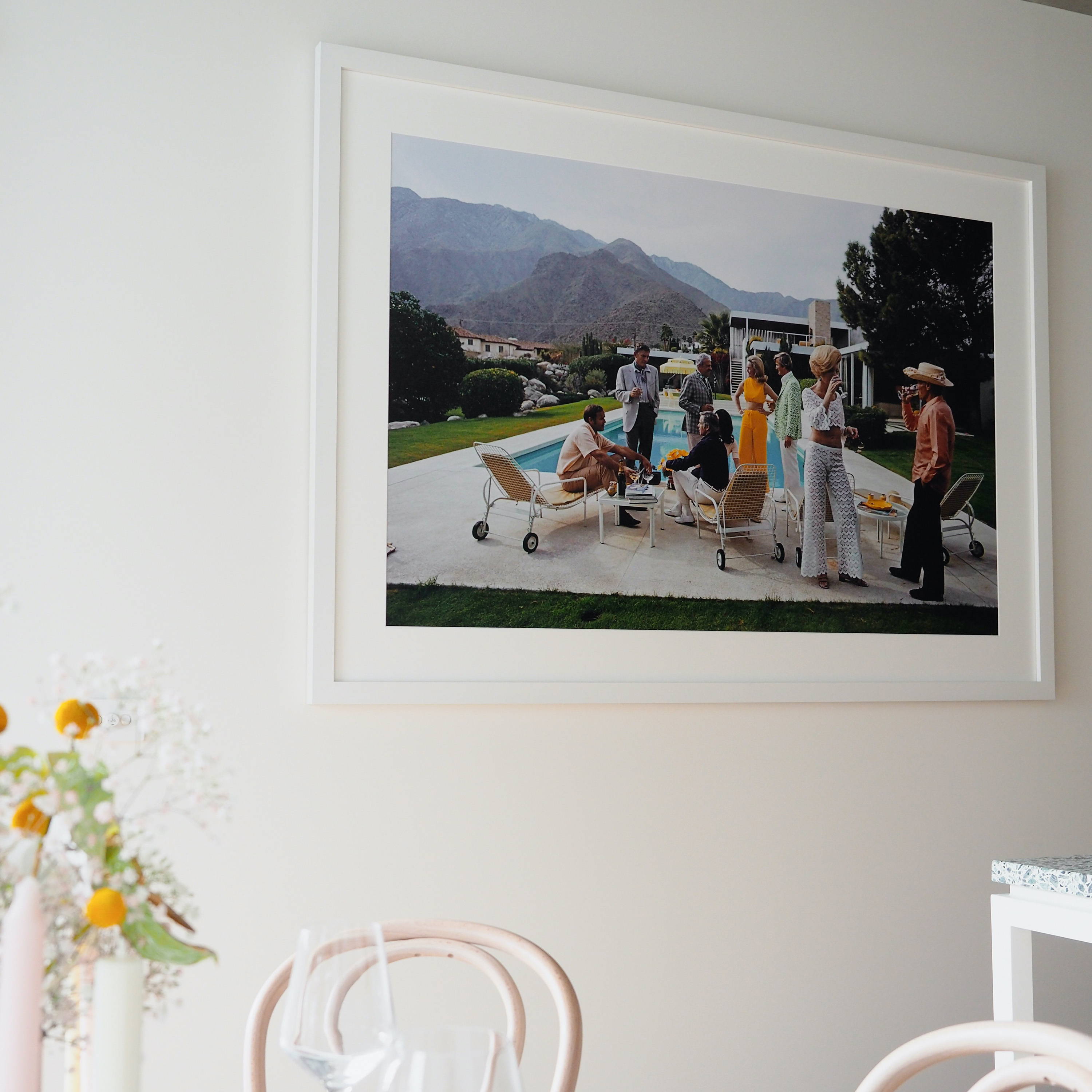 Desert House Party by Slim Aarons. Framed photographic print hanging in a dining space.