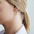 Gold Textured Semi-hoop earrings on model | Lily Gardner London
