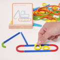 A hand placing colorful wooden sticks to create a design illustrated on a playing card featured in the Montessori Smart Sticks.