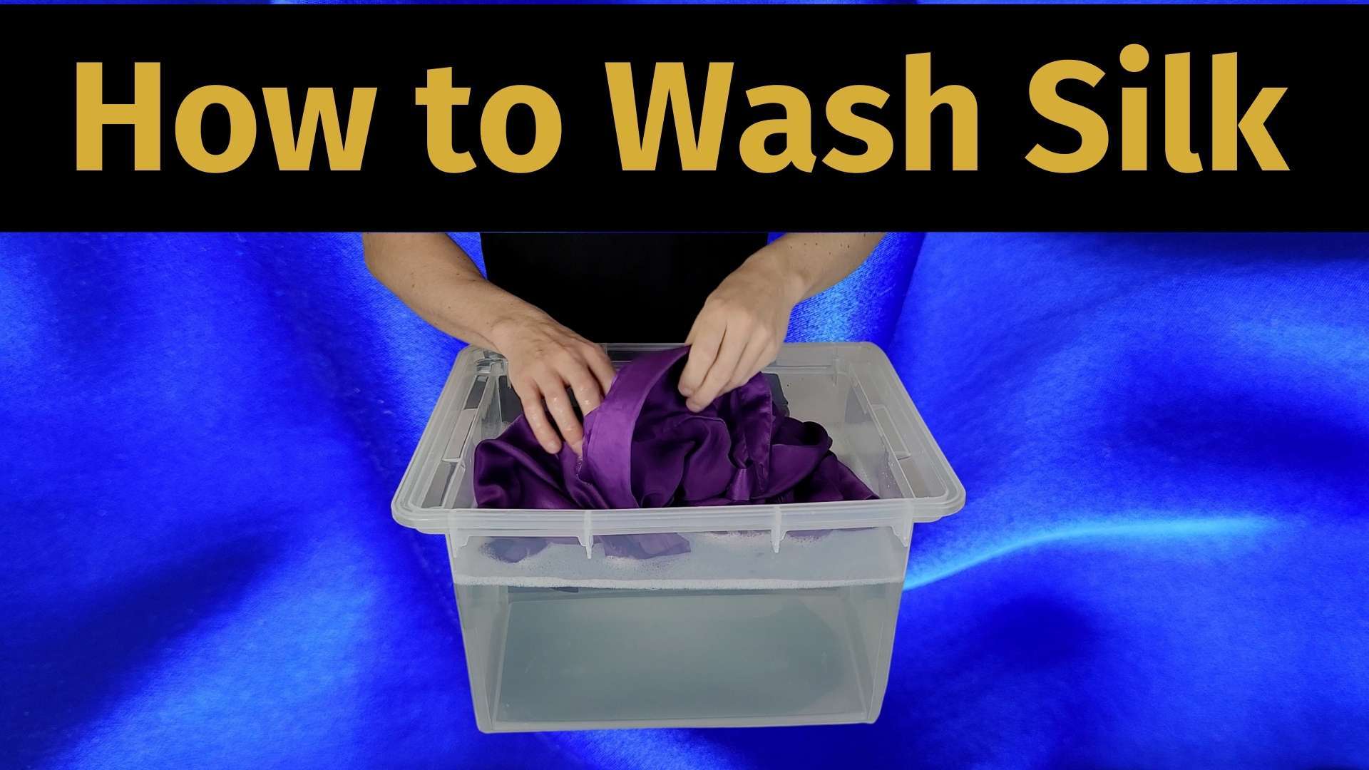 how to wash silk banner image with a picture of a man hand washing a silk shirt in a bucket full of lukewarm soapy water