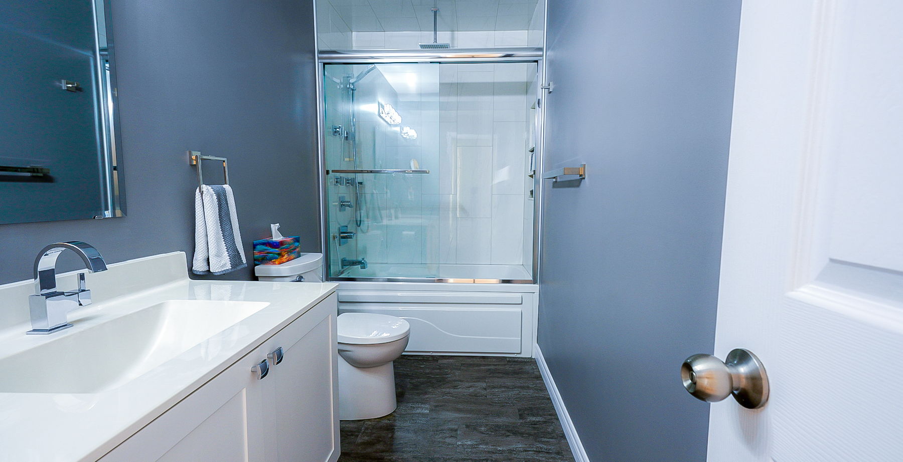 full bathroom with hardwood flooring, toilet, mirror, vanity, and combined bath / shower with glass door
