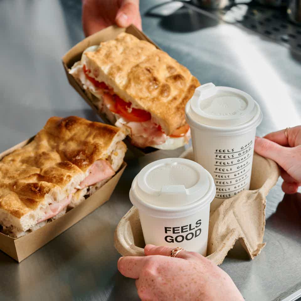 Takeaway sandwiches and coffees on a countertop