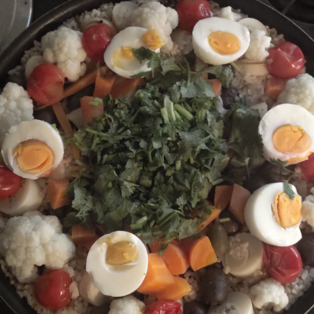 Paella Teia with cauliflower, black olives, palm hearts, carrots, eggs, tomatoes, coriander leaves
