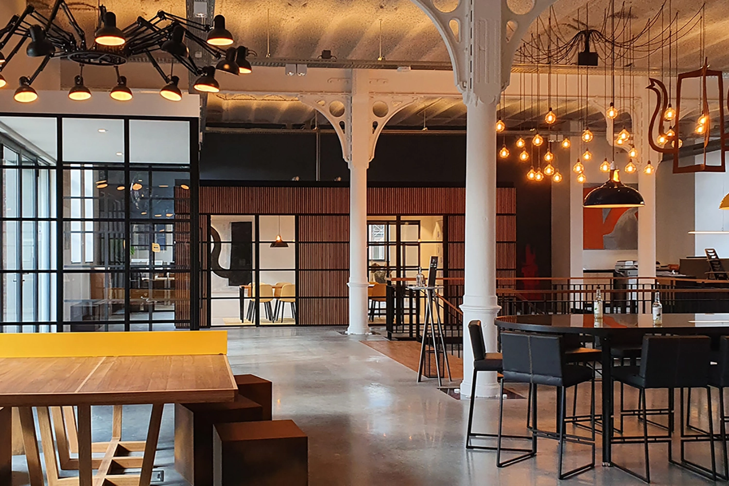 A Large Royal Blue Coolicon shade hangs over a bar area