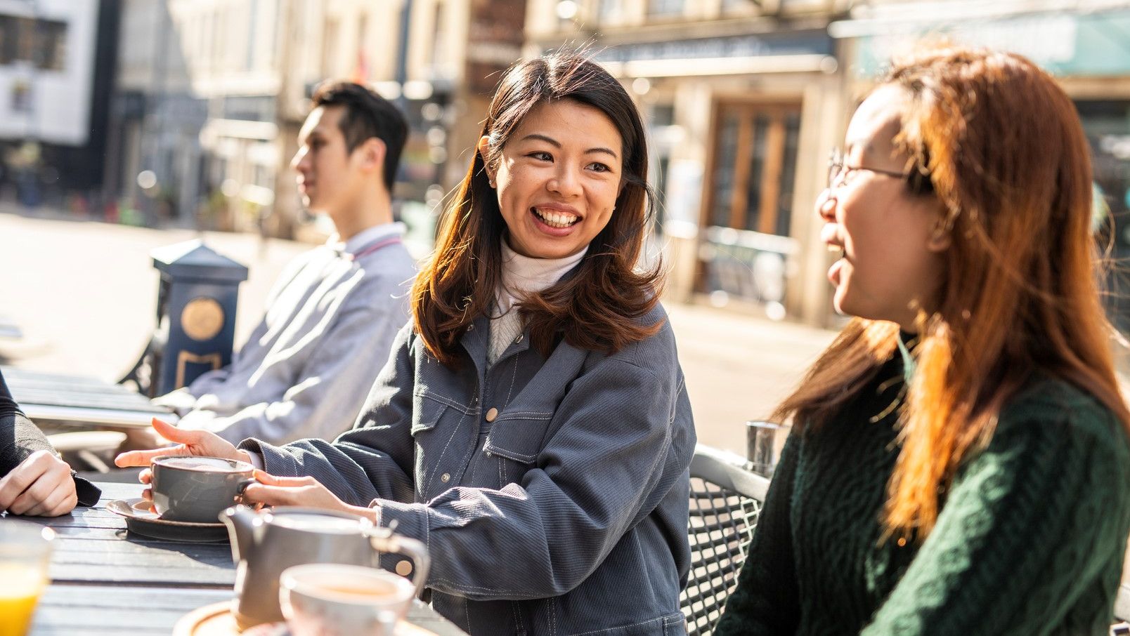 Women smiling at an outdoor café