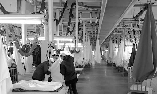 Workers helping in the sheets manufacturing process