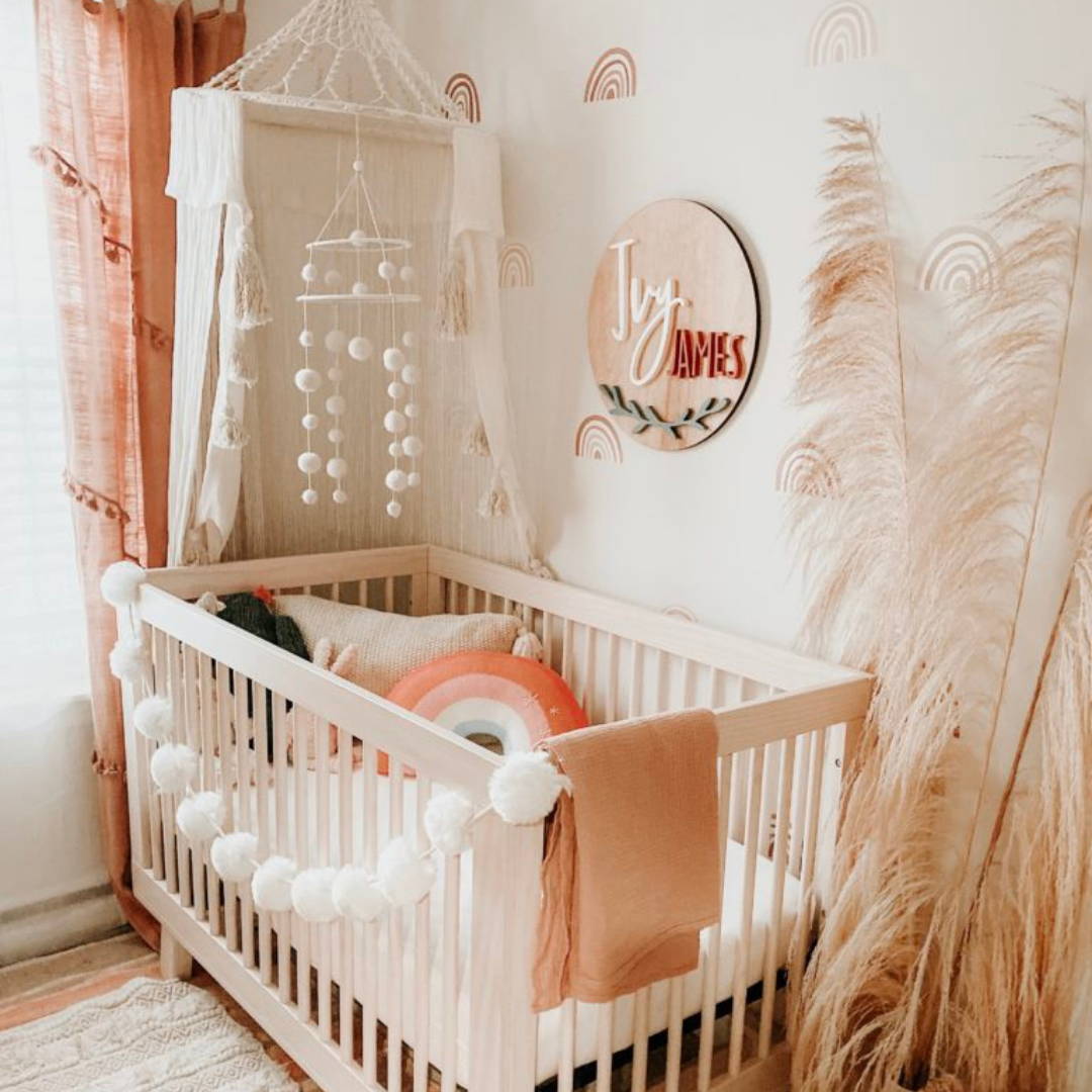 boho theme neutral nursery with crib and crib canopy