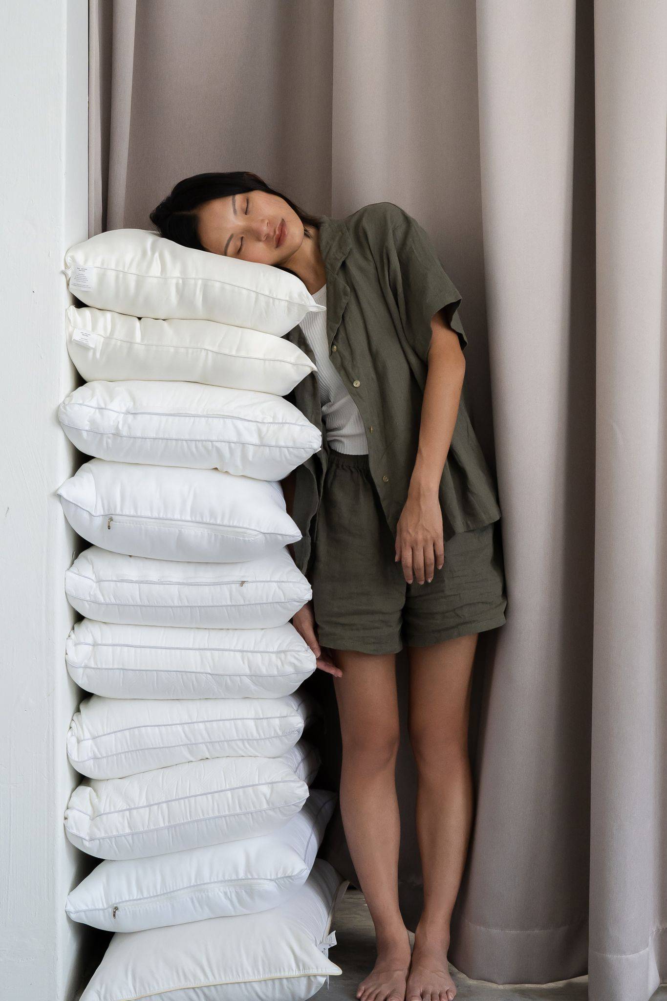 Stack of pillows and a girl leaning on it
