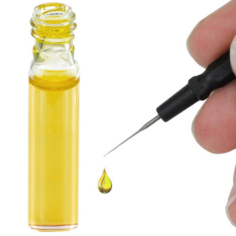 oil used for watch lubrication and a human hand using it.