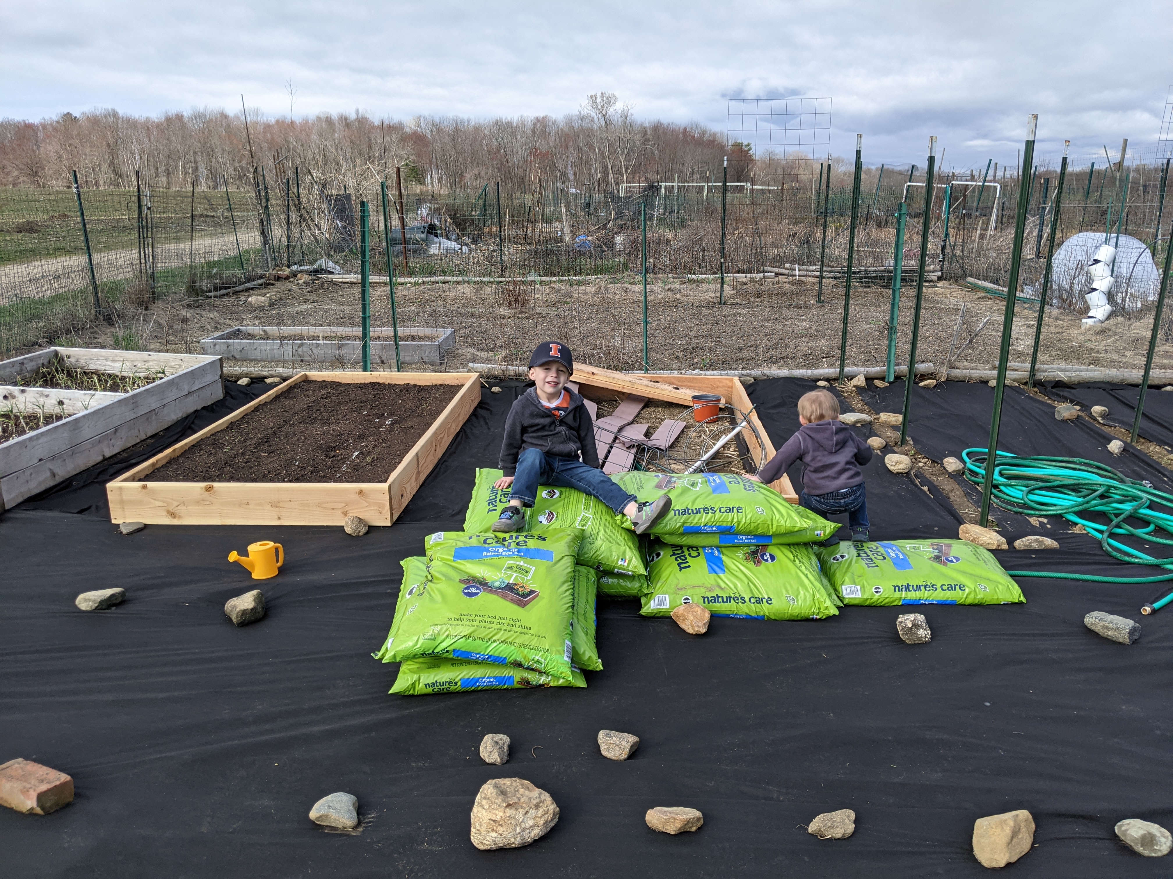 My kids having a great time climbing soil bags when I was setting up the garden.