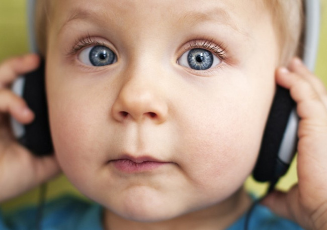 Music is essential for early childhood development. This photo shows a primrose student listening to music with headphones.