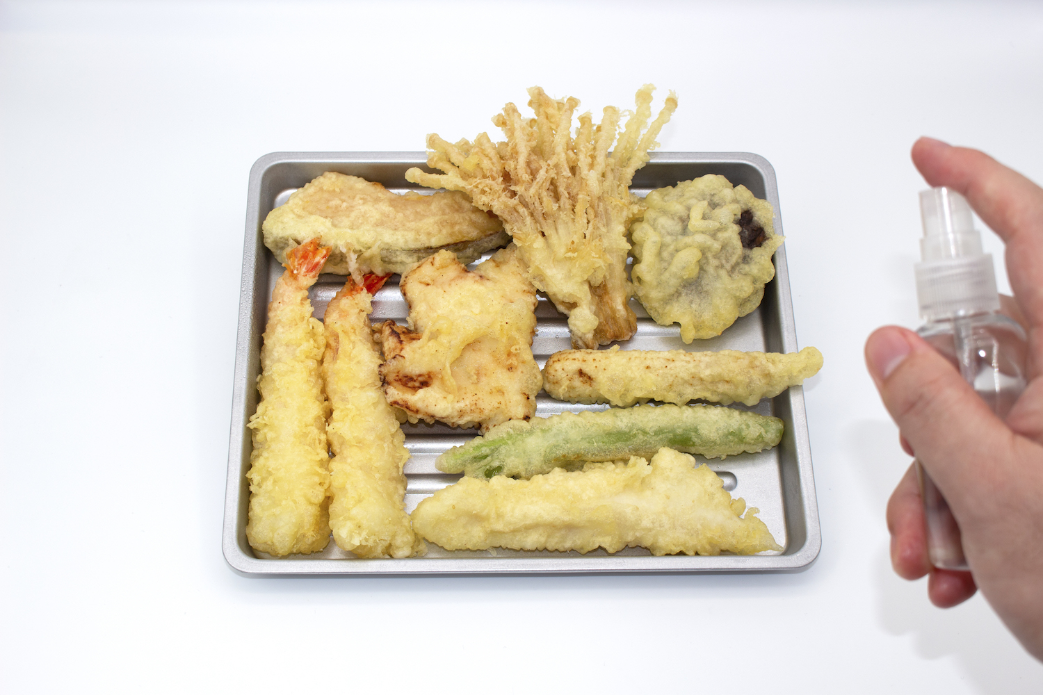 Step 1. Lay tempura on a tray and moisten it by spraying it with water