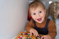 Toddler playing with Montessori puzzles. 