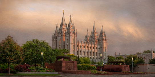 Salt Lake Temple against a cloudy sky. 