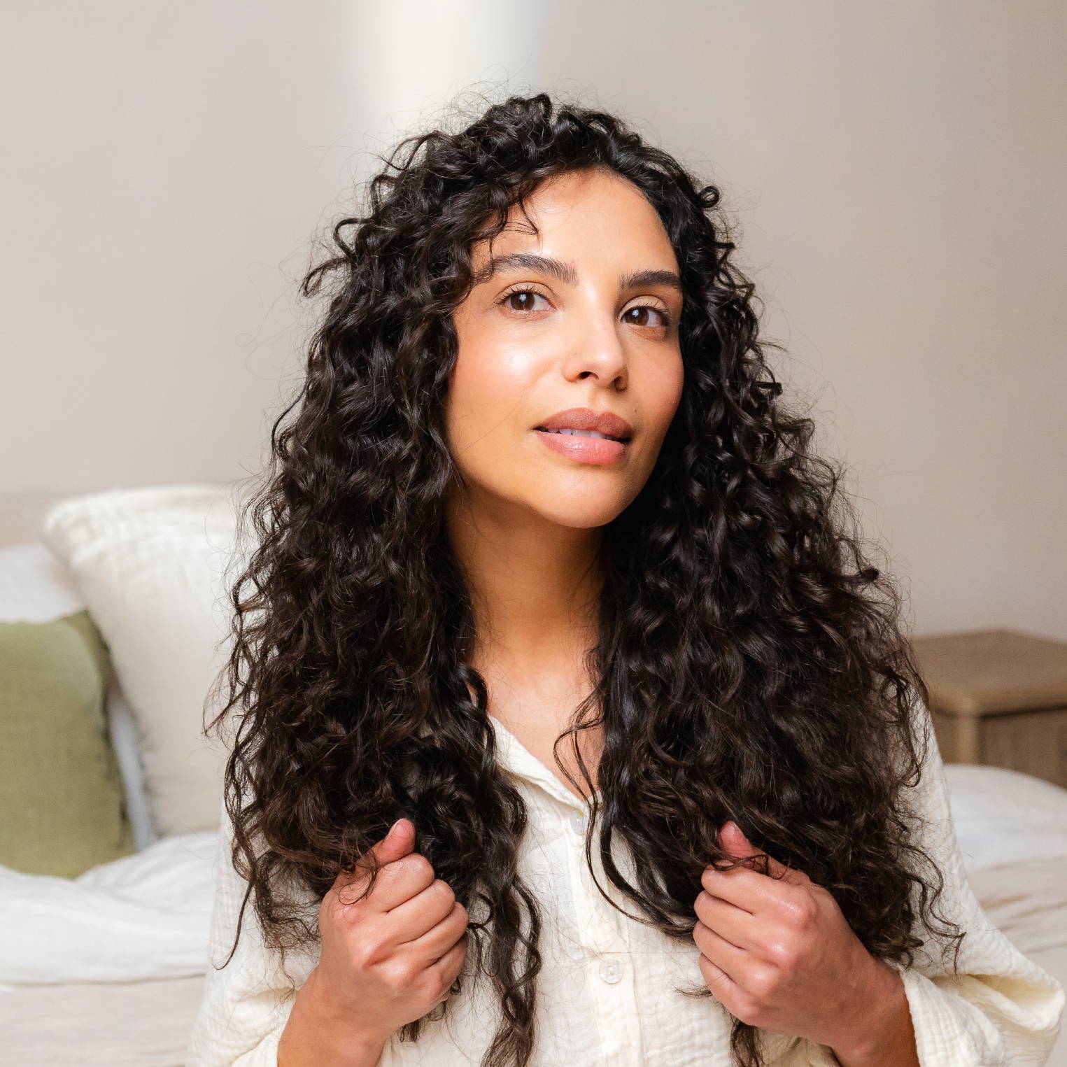 Davines hair model with long, brown curls