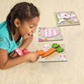 Little girl enjoying while playing with Montessori Easter Wooden Puzzles.