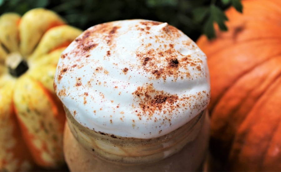 Pumpkin pie smoothie topped with cream and cinnamon