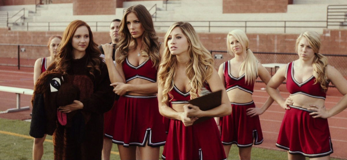 The cheerleaders confronting someone off camera all with their hands on their waists and annoyed expressions.