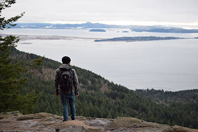 A hiker looking out over the bay from Oyster Dome.