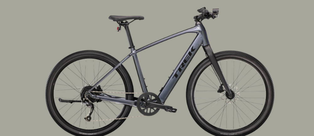 a silver Trek Dual Sport+ 2 electric city bike