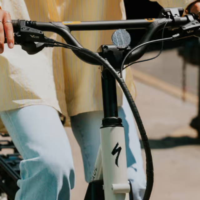 Mechanic inspecting ebike on repair stand