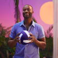 man wearing a buttoned up t-shirt holding a purple and white volleyball 