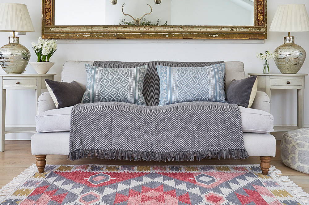 Gorgeous Weaver Green Andalucia Zahara rug with herringbone blanket and cushions