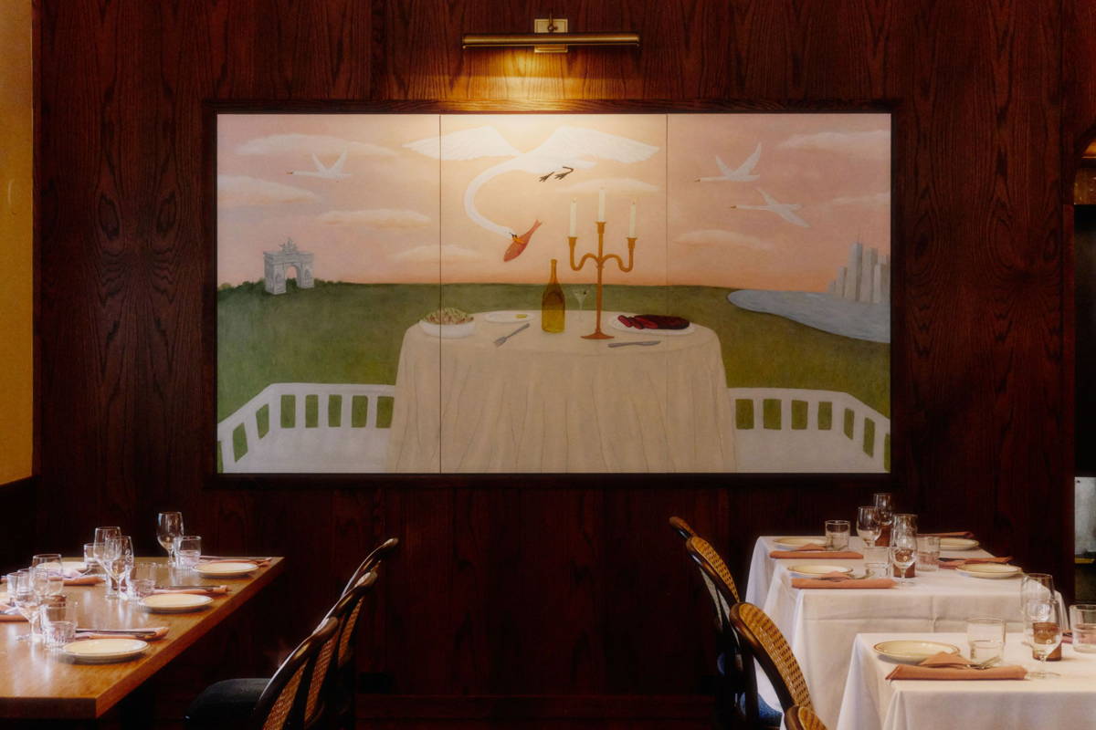Large painting of a dining table with candelabra mounted on wall of a restaurant in dining room.