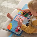 Child playing with a Montessori Story Book.