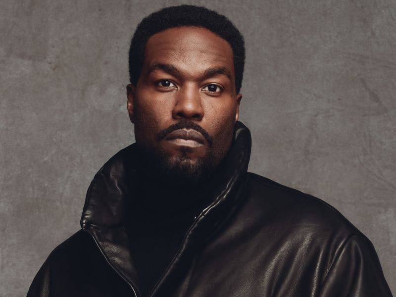 Image may contain: Yahya Abdul-Mateen II, Clothing, Coat, Jacket, Face, Head, Person, Photography, Portrait, and Body Part