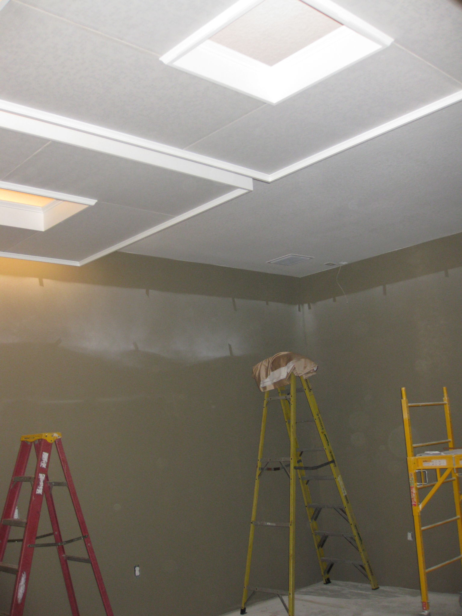 Hanging 6'x6' wood frame acoustic "clouds" with all-thread from the ceiling joists room centered.