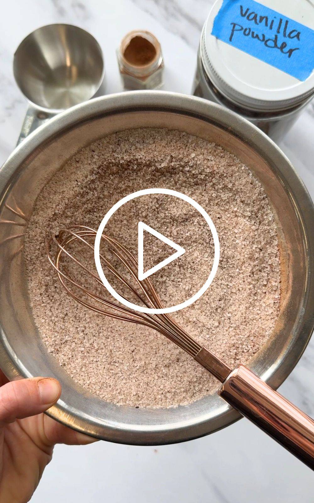 A thumbnail image of a dark brownish spice inside a metal bowl with a whisk
