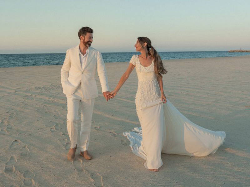 Image may contain: Billy Holland, Body Part, Hand, Person, Holding Hands, Adult, Wedding, Clothing, and Coat