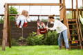 Kids swinging from a traditional swing