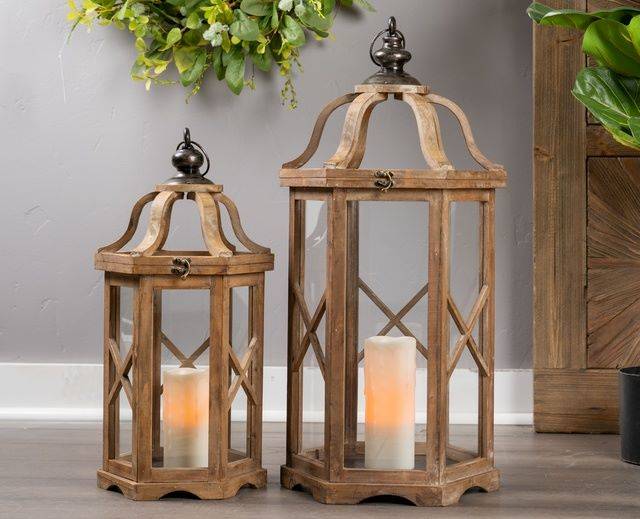 pair of wood lanterns with pillar candle