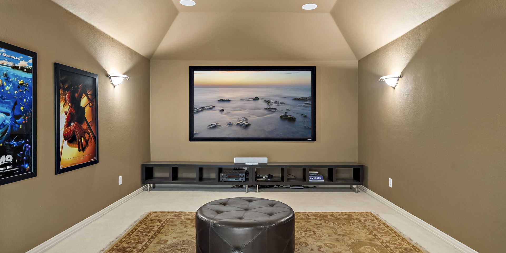 cinema room with carpet and lofted ceiling
