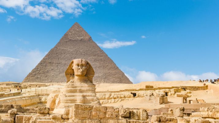 Blue skies and pyramids behind the Great Sphinx of Giza