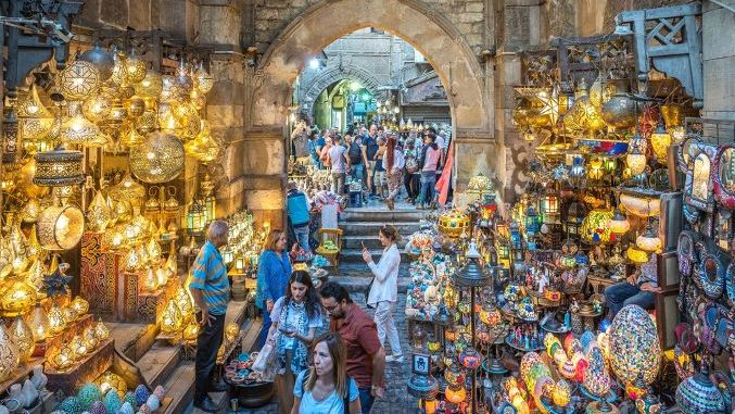 Cairo, Egypt - October 25, 2022. View of the tourists buying sourvenirs in the Khan el-Khalili bazaar.