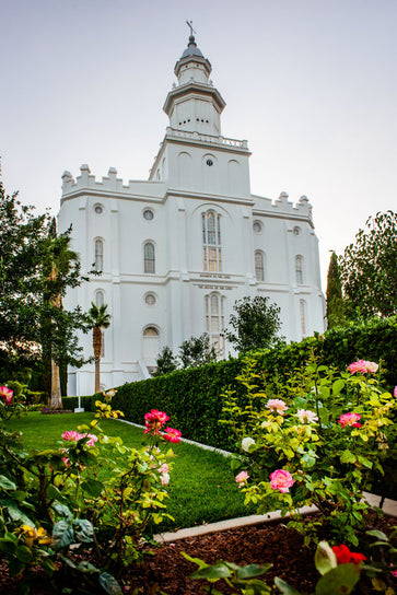 St. George Temple standing behind a green lawn with flowers.