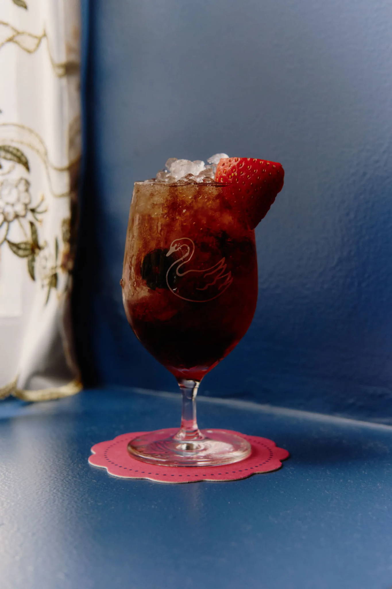 Drink in glass cup with strawberry.