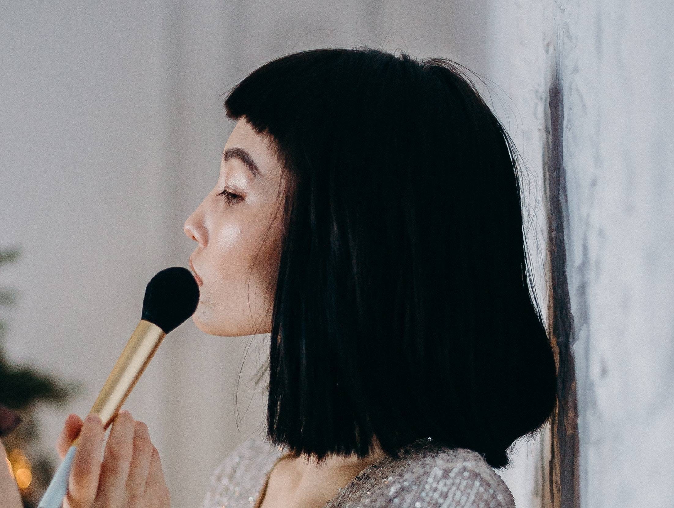 Woman applying makeup