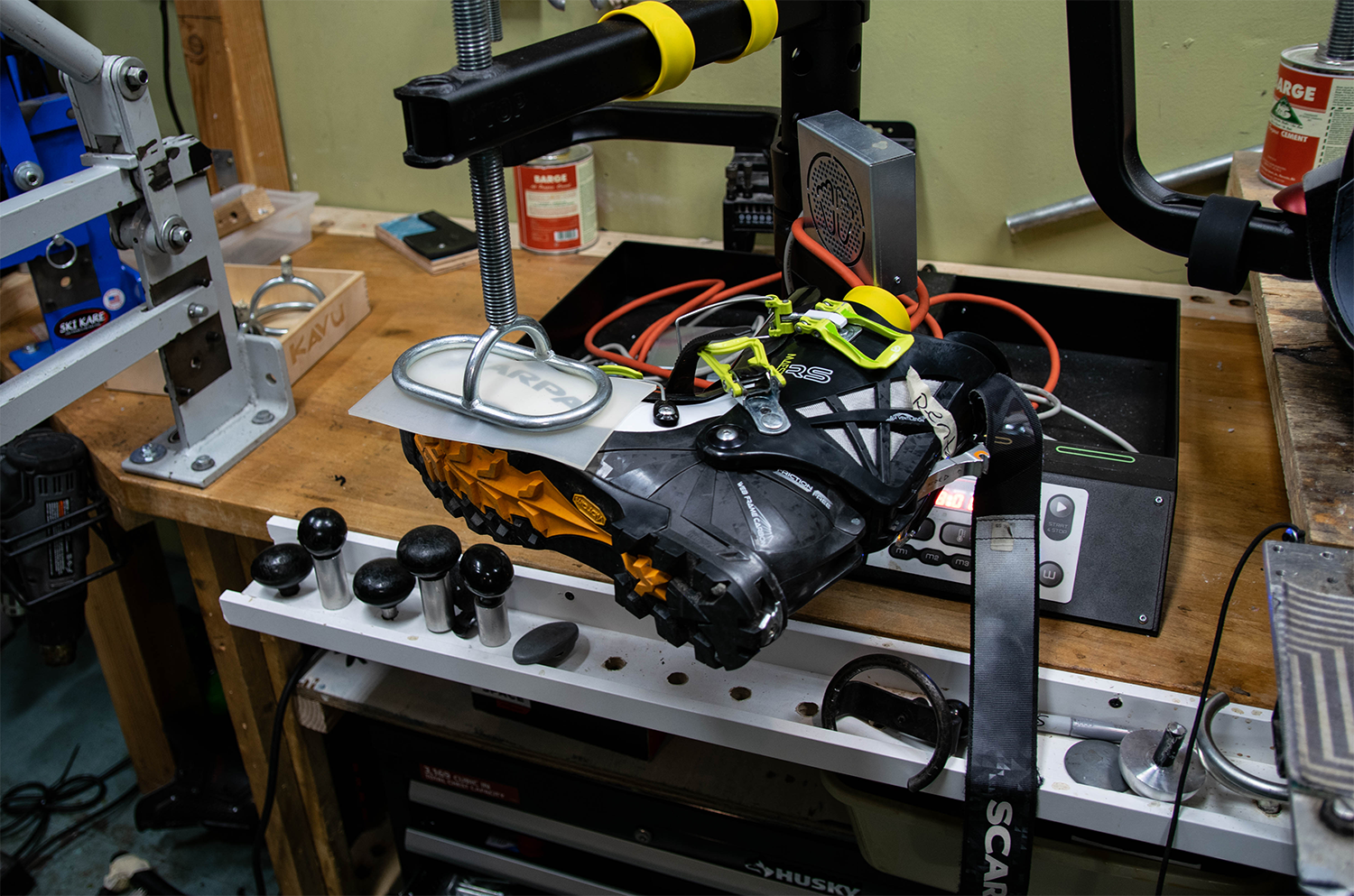 A ski boot getting modified by a boot press.