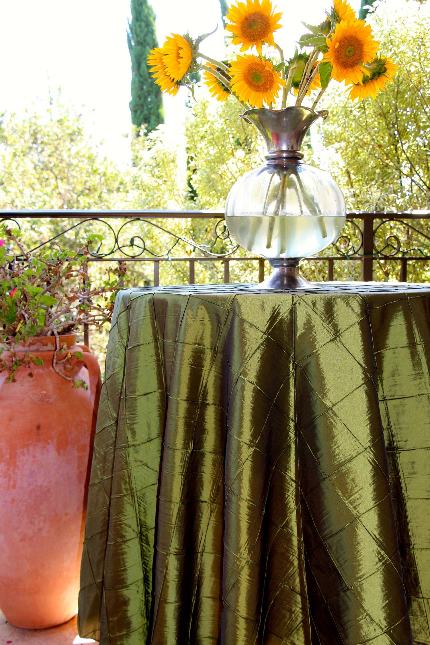 round bombay pintuck tablecloth with a jar of natural sunflowers over it
