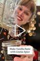 A person smiles while pouring vanilla paste out of a blender into a jar