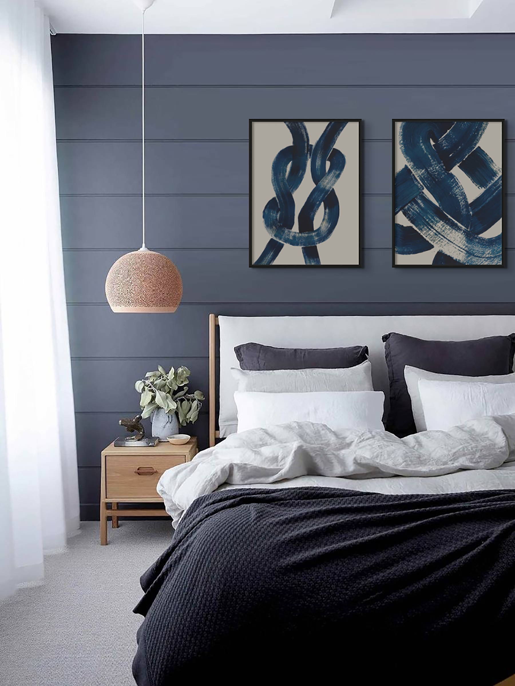 abstract line art on a blue panelled wall in a bedroom