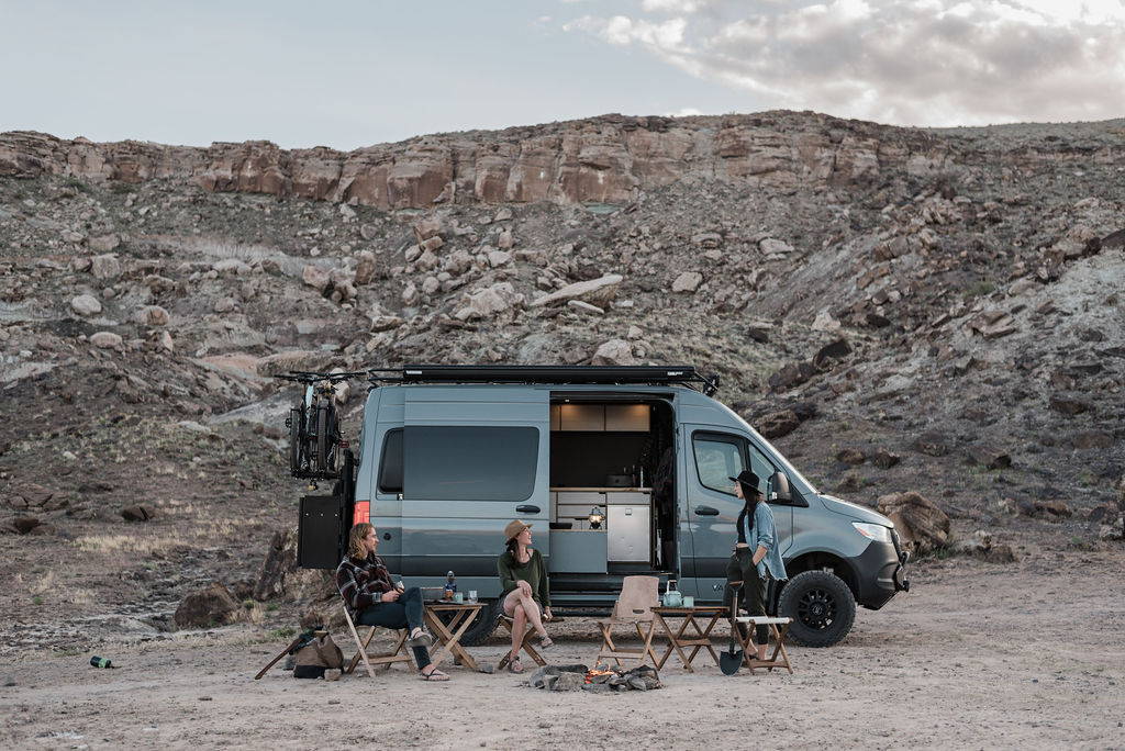 Rack & Roll - Sprinter 144 Van Conversion - Woman and Children Enjoy View from Lofted Bed - The Vansmith